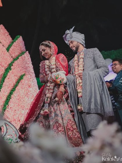 The couple walks together during their pheras, a beautiful moment of unity. We capture this against the backdrop of their stunning floral decor.