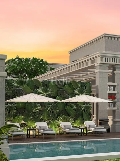 The verdant greenery enveloping this pool area creates a serene backdrop against the shimmering water. This harmonious fusion of a classical architectural theme and natural elements elevates the poolside experience into a truly lavish retreat.