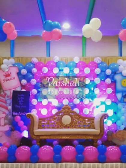 I love creating fun and playful themes for kids' parties and baby showers. This setup uses bright pink and blue balloons, cute baby character cutouts, and a decorated stage to make the celebration vibrant and joyful.