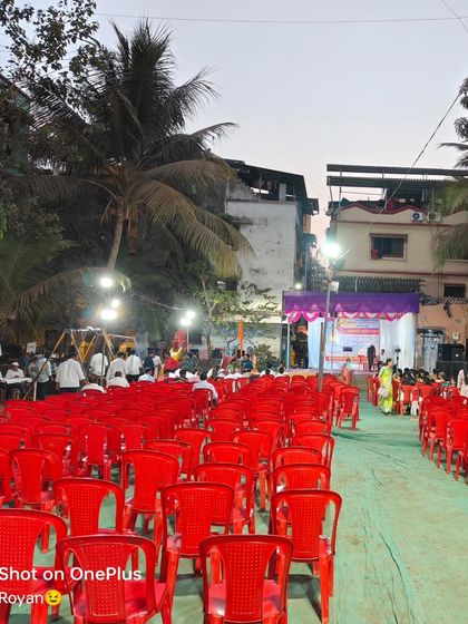 Another view of the outdoor seating arrangement, showing the large number of chairs provided for the event.