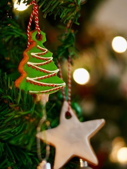 Our hand-decorated gingerbread cookie, designed as an edible Christmas tree ornament. It’s a charming and delicious token gift for children and adults alike during the holiday season.