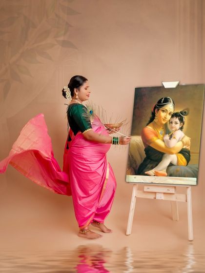A creative and divine concept, showing the mother-to-be as an artist painting a portrait of Yashoda and Krishna. This image beautifully connects her own journey to the timeless story of motherly love.