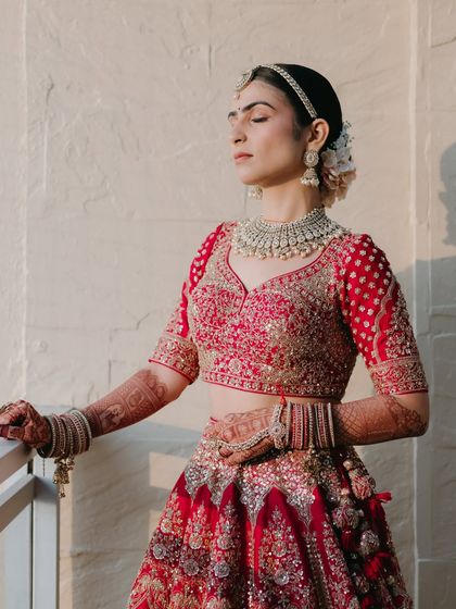 Basking in the golden hour sun. The natural light beautifully highlights her radiant skin and the soft, blended eye makeup.