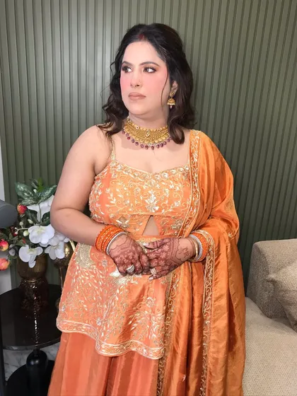 A full shot of the client's Karwa Chauth look, her gold choker and bangles adding a festive touch.