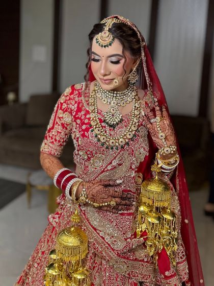 A close-up of the bride's pose with her kalire. You can see the detail in her soft brown smoky eye makeup and the flawless, glowing skin.