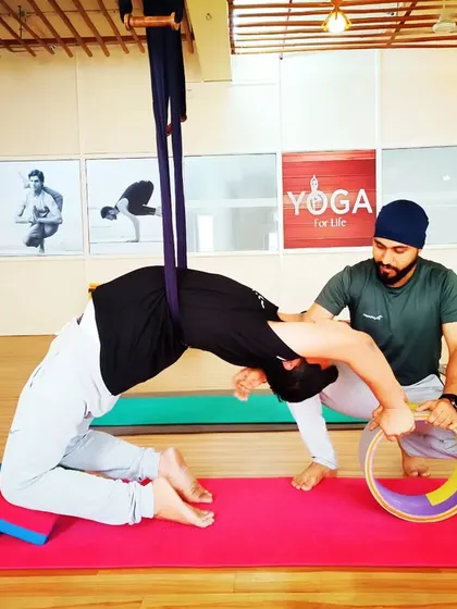 Here, I am helping a student use the yoga wheel to open his upper back and shoulders. This kind of targeted work is great for relieving stiffness.