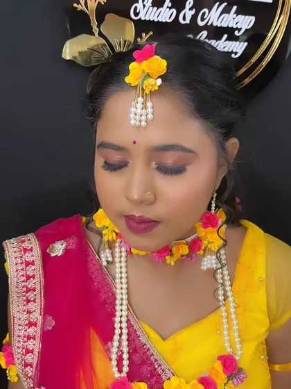 A serene portrait with eyes closed, highlighting the delicate eye makeup for the Haldi look.