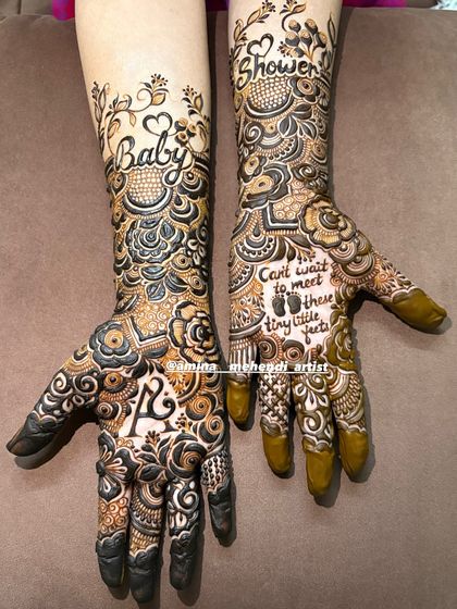 Another angle of the fresh baby shower mehendi, highlighting the delicate vines on the forearm and the personalized details on the palms.
