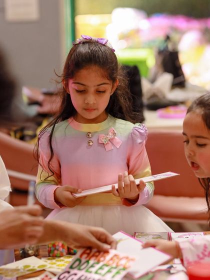 A girl proudly shows off the craft she has just completed. Kids love being able to take home something they made themselves.