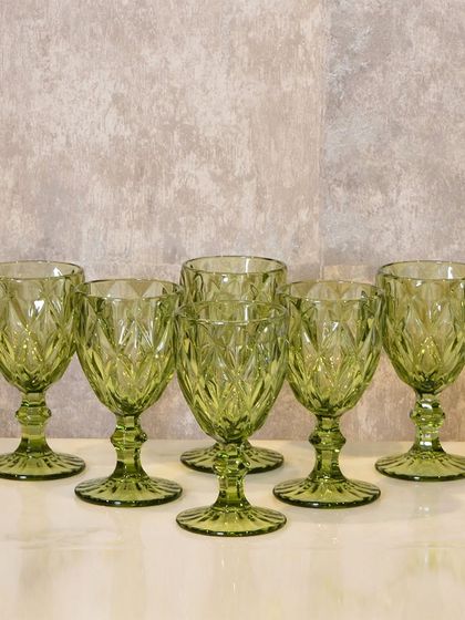 These beautiful green glass goblets add a pop of color and vintage charm to your dining table, perfect for serving water or wine.