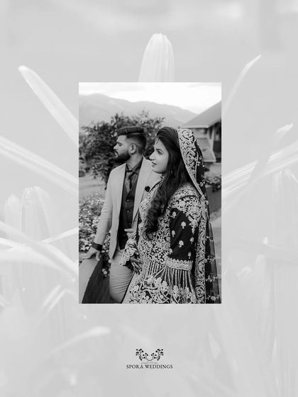 A beautiful black and white portrait of the couple, framed by soft, out-of-focus foliage.