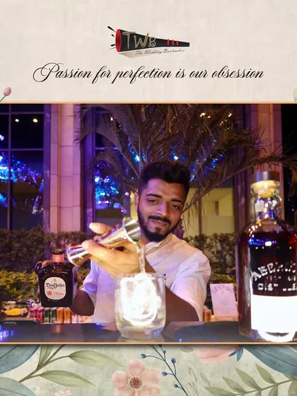 A bartender focuses intently on his craft, pouring a drink with precision and care.