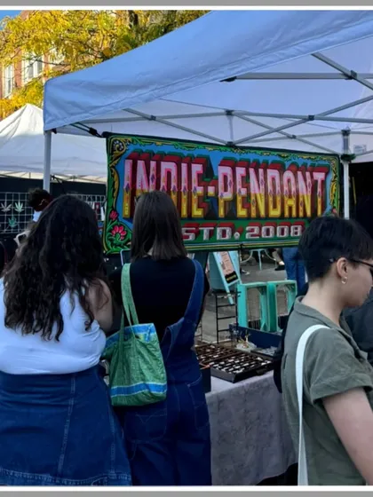 My hand-painted banner for "Indie-Pendant" on display at a market stall. It's rewarding to see my art helping small businesses attract customers.