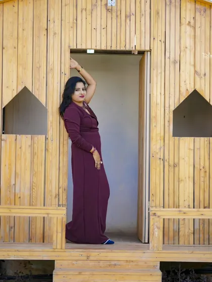 A stylish pose in the doorway of a rustic wooden cabin. This set is great for creating a cozy, natural-themed photoshoot.