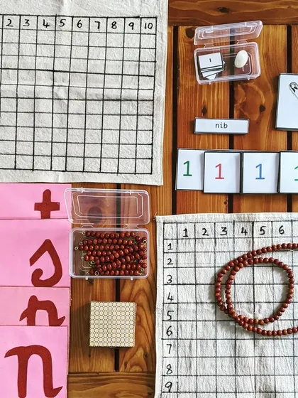 Each at-home kit is a treasure box of discovery, carefully prepared and handmade by me. This particular set includes materials for both math and language, like bead chains for counting, number cards, and phonetic object cards. It provides everything you need to bring a rich, hands-on learning environment into your home.