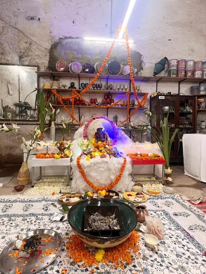 A wide view of our studio's Ganesh Chaturthi pandal setup. The space is transformed with flowers, lights, and offerings, creating a sacred and festive atmosphere for our community to gather and pray.