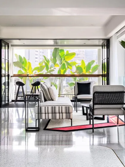 The kitchen in our House of Basho project is designed for slow living, with a focus on natural materials and a connection to the outdoors. A large window overlooks a private garden, bringing in light and greenery.