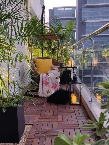 A cozy reading corner is a must have for any home. We added a comfortable swing chair with a plush cushion and throw, surrounded by plants and lanterns, to create the perfect spot to unwind on this balcony.