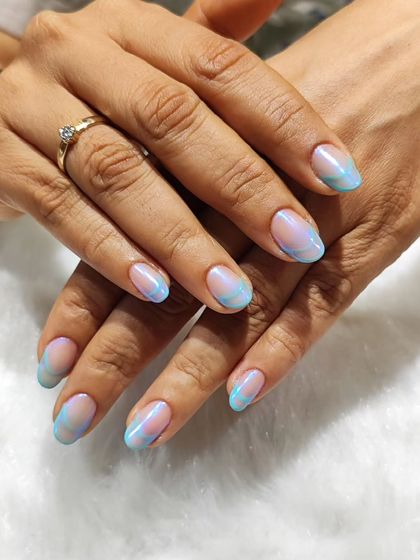 An electric twist on a classic. This design uses swirls of pastel blue and pink to create a dreamy, watercolor effect on the tips of the nails.