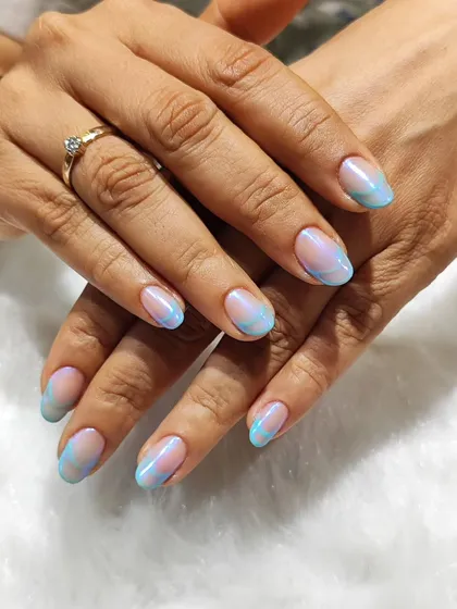 An electric twist on a classic. This design uses swirls of pastel blue and pink to create a dreamy, watercolor effect on the tips of the nails.