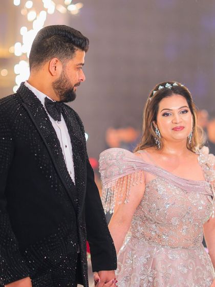 An intimate moment between the couple at their engagement party. The bride's makeup is minimal and luxe, with glowing skin and softly defined eyes.