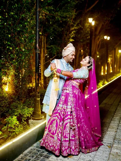 A romantic dance pose in a beautifully lit pathway.