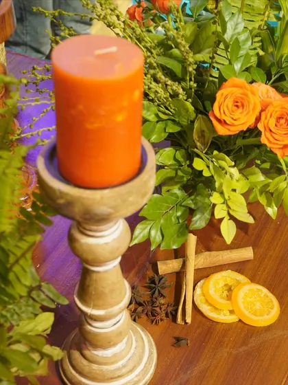 A close-up of the aromatic details from our 'Moroccan Nightfall' event, including scented candles, cinnamon sticks, and dried orange slices.