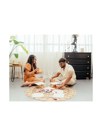 A wide shot of the studio setup for the painting session, showing the couple sitting on the floor, surrounded by art supplies.