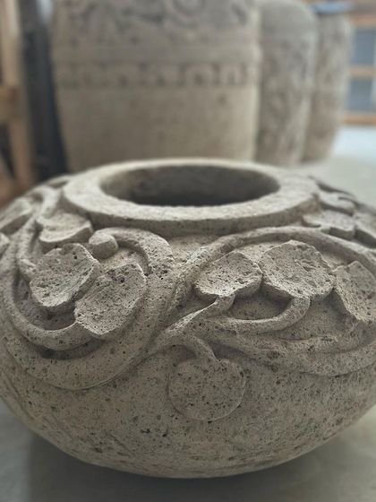 The 'Daun' planter, a small, bowl-shaped piece with delicate leaf carvings around the rim. Perfect for a tabletop.