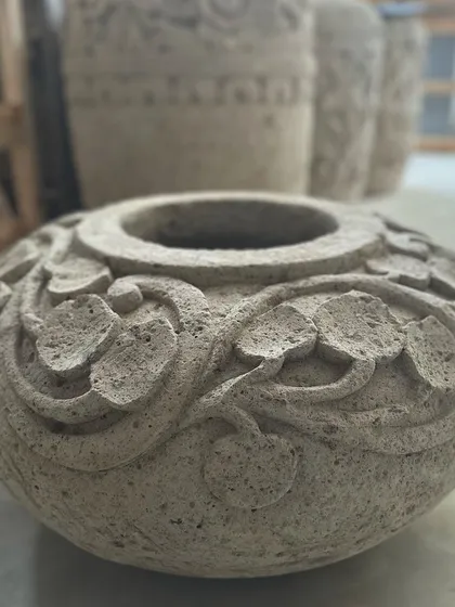 The 'Daun' planter, a small, bowl-shaped piece with delicate leaf carvings around the rim. Perfect for a tabletop.