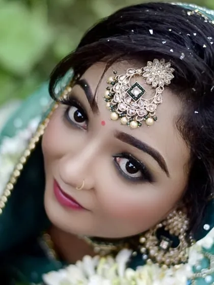 This artistic shot from above highlights the intricate details of the maang tikka and the perfectly blended eye makeup. It’s a modern take on a classic bridal portrait.