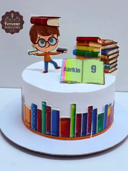 A book theme cake for a young reader. This chocolate truffle cake is decorated with a border of books and topped with a cartoon of a boy with his books.