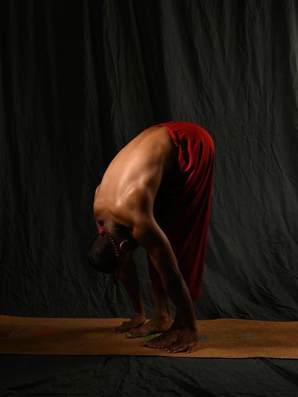 A modified Uttanasana (Standing Forward Bend) with bent knees. For those with tight hamstrings, bending the knees is crucial to allow the spine to lengthen fully, which is the primary goal of the pose.