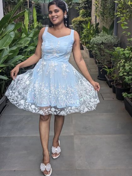 A cute and playful mini frock in a lovely sky blue with white floral embroidery. Perfect for a brunch, day party, or a casual celebration.