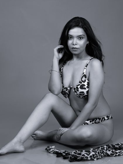A black and white version of the animal print bikini shot, adding a timeless and classic feel to the swimwear portrait.