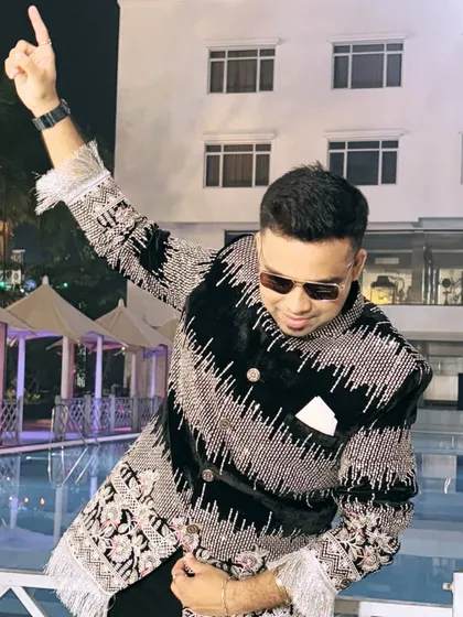A fun, celebratory pose in the same black and silver sherwani. Even in the most royal attire, my high-energy personality always shines through.