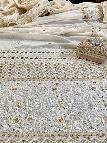 A styled flat-lay of the saree, showing its full glory with a matching clutch, perfect for a wedding or grand event.