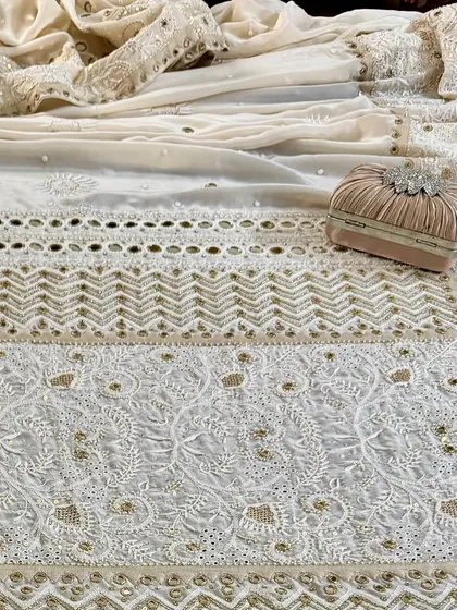 A styled flat-lay of the saree, showing its full glory with a matching clutch, perfect for a wedding or grand event.
