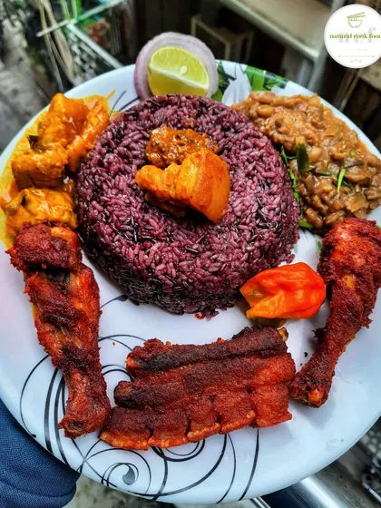 A special meal featuring Manipuri black rice, known for its nutty flavour. This thali includes crispy fried pork ribs, chicken drumsticks, a rich pork curry, and a side of eromba.