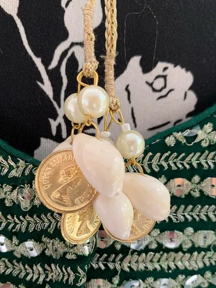 Even the tie-ups on the blouse have beautiful details like cowrie shells and pearls.