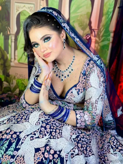 A powerful and confident pose. The makeup is bold and striking, designed to make a statement.