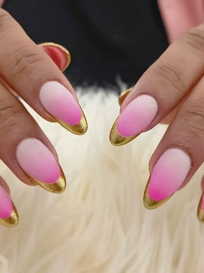 A close-up of the matte pink ombré and gold tip combination.