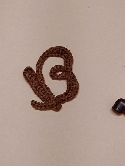 Bold and Beautiful. Here is the letter 'B' in the crochet calligraphy series, shown in a lovely brown color.
