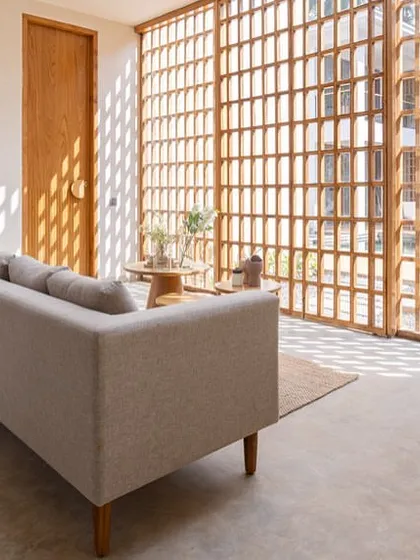 This dining area in our House of Veils project features a custom-designed table and chairs, with a focus on clean lines and a minimalist aesthetic. The space is open to the living area, creating a sense of flow and connection.
