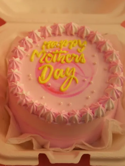 A close-up of one of our Mother's Day bento cakes, featuring delicate pink piping and a sweet message.