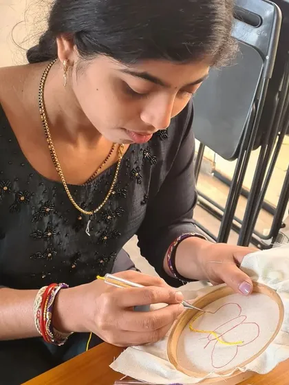 A student carefully traces her butterfly design with the punch needle. The first few stitches are always the most exciting part of starting a new project.