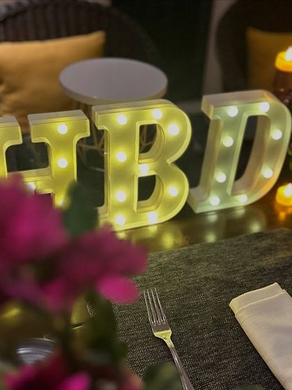 A beautiful shot of the floral arrangement and light-up letters, showcasing the simple elegance of the setup.