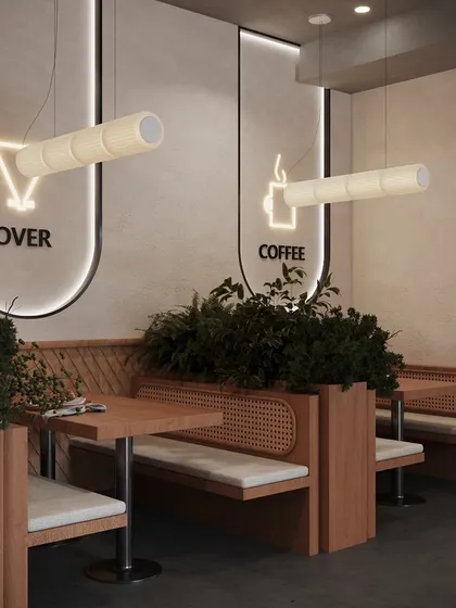 We believe in creating a variety of seating experiences. Here, we designed cozy booths with integrated planters that provide privacy and a touch of green. The minimalist neon signs and custom tube lighting add a trendy, modern touch, making this the perfect spot for conversation.