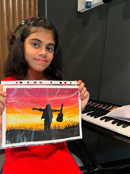 Our students are multi-talented! Here's our piano student Gaby showing off a beautiful piece of art she created, inspired by her love for music.