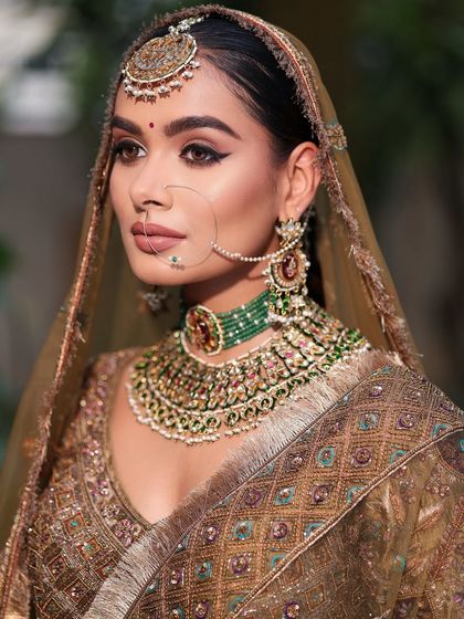 A classic bridal portrait. The makeup enhances her features, creating a look of pure elegance and royalty for her big day.